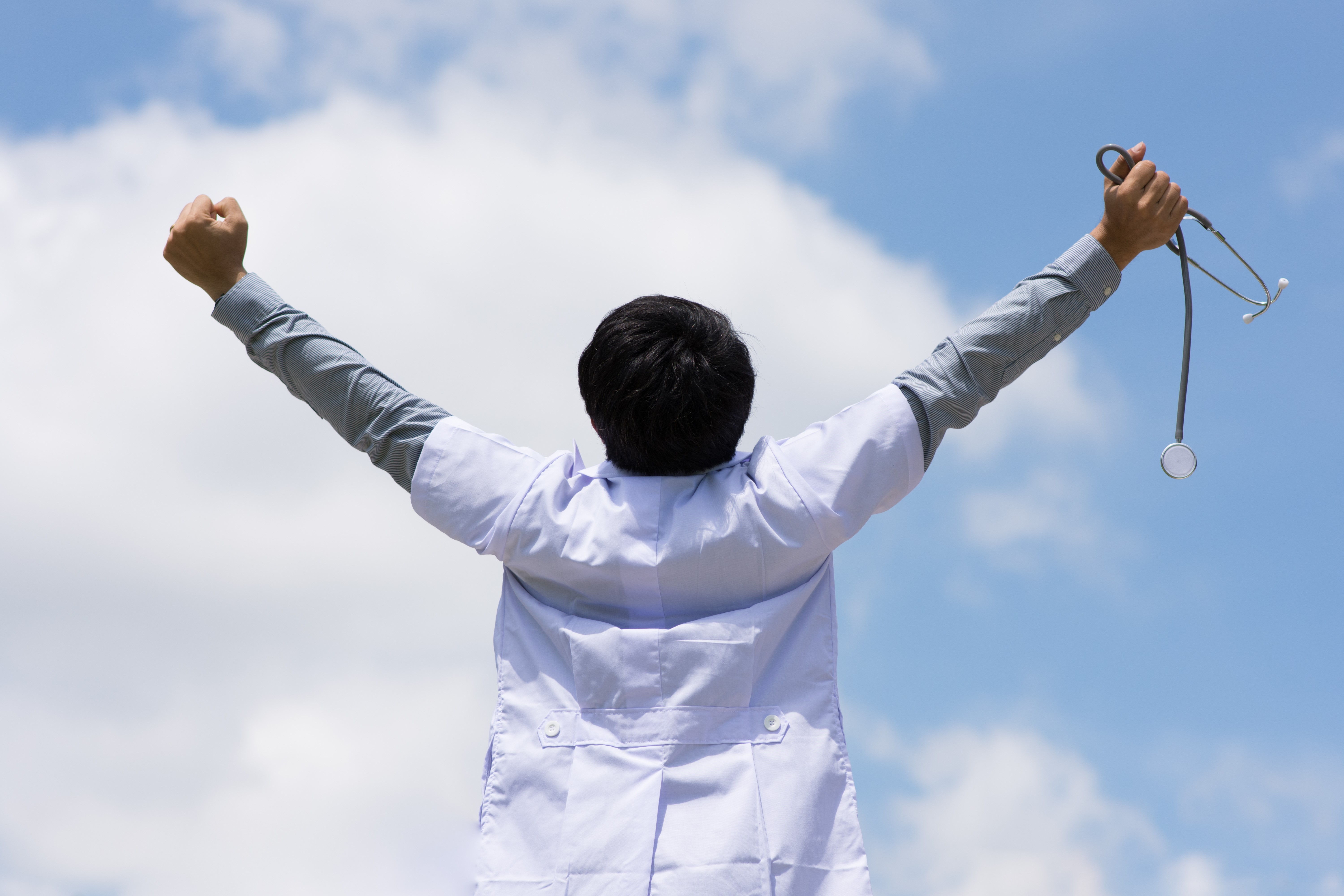 Doctor raising hands triumphantly